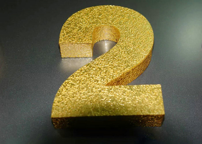 Laser cuttin burnishing the letter with gold foil finish