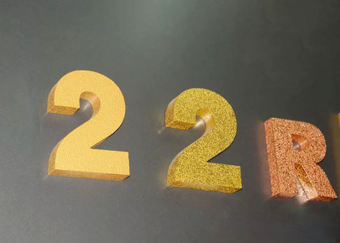 Burnishing the letter with gold foil finish