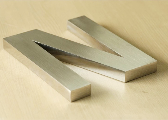 Laser cut brushed stainless steel letters